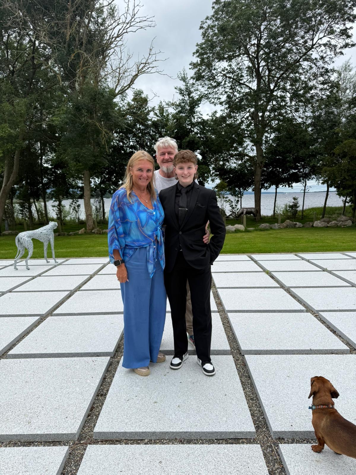 Me with my parents at a family event by the lake